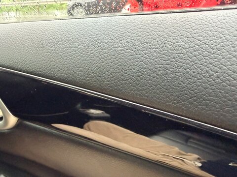 Car Interior Door Panel with Raindrops on Window