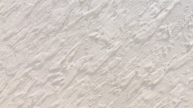 White and beige plaster wall texture background with diagonal brush strokes pattern for interior design and architecture backdrop