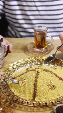 woman preparing tamina is the name of algerian food is base with semolina and honey, this is a tradition sweet food for mawlid or ramadan