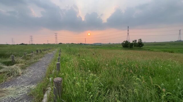 Hefei Xiao Lingnan Rural Sunset: Gravel Path and Power Towers Under Golden Dusk Countryside Scenery