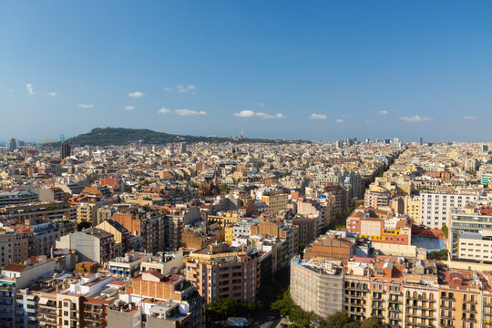 Panoramic Aerial View of Barcelona Cityscape with Montjuic Hill and Clear Blue Sky, Spain