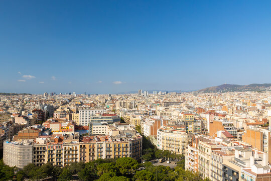Panoramic Aerial View of Barcelona Cityscape with Montjuic Hill and Clear Blue Sky, Spain