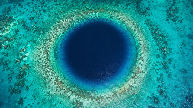 Ocean Blue Hole Aerial View with Circular Deep Water Sinkhole and Turquoise Coral Reef