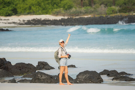 Tourist photographer on Galapagos Islands volcanic beach