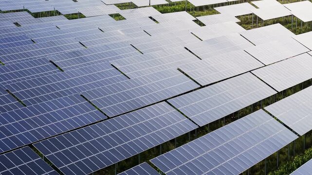 Aerial view moving forward and tilting down over photovoltaic solar panel array, renewable green energy, sustainable clean power for ESG, ecological documentaries, tech ads.