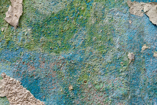 Old grunge texture with green, blue and beige tones, featuring cracked paint, peeling surfaces, faded colors, rough details, and a weathered vintage look.