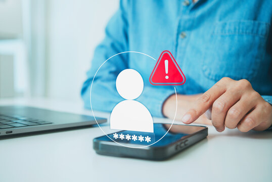 Mobile account security alert with person tapping smartphone beside laptop to review suspicious access protect passwords prevent identity theft and strengthen digital privacy.
