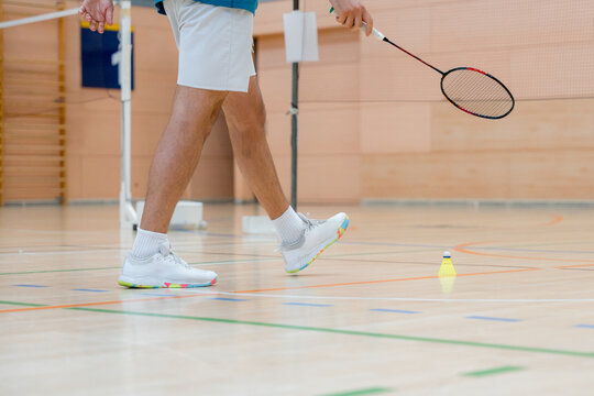Badminton tournament detail with player racket and shuttlecock