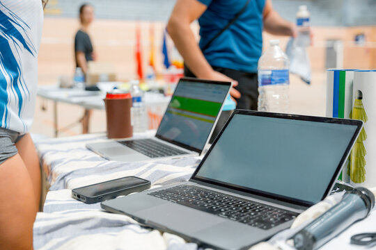 Laptop registration desk at women's badminton tournament