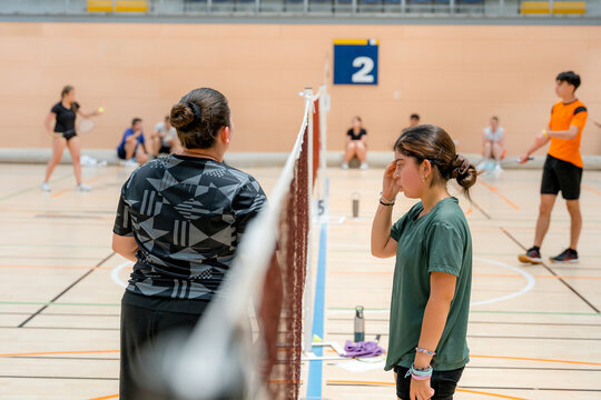 Female badminton player pause during indoor tournament match