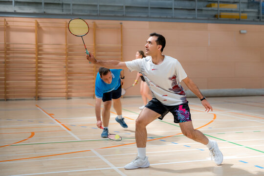 Badminton player compete in indoor tournament match