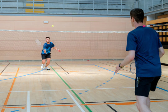 Badminton player compete in indoor tournament match