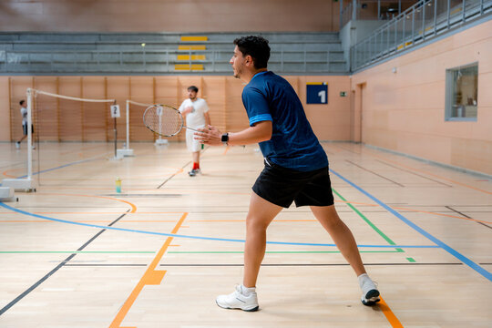 Badminton player competing in indoor tournament match