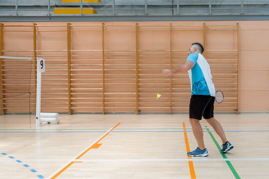 Badminton player compete in indoor tournament match