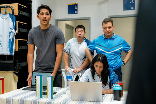 Badminton tournament team review scores on laptop