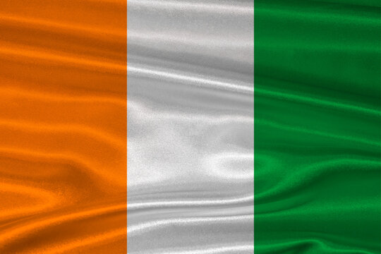 Ivorian flag textured with fabric background. Flag of Ivory Coast with a soft fabric texture