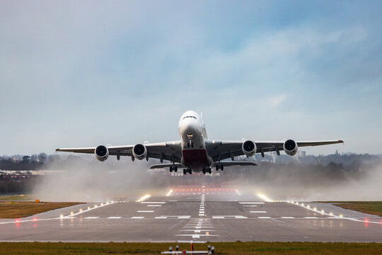 Large passenger jet taking off from a rainy runway