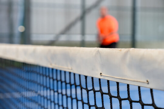 Padel net in focus during a doubles match