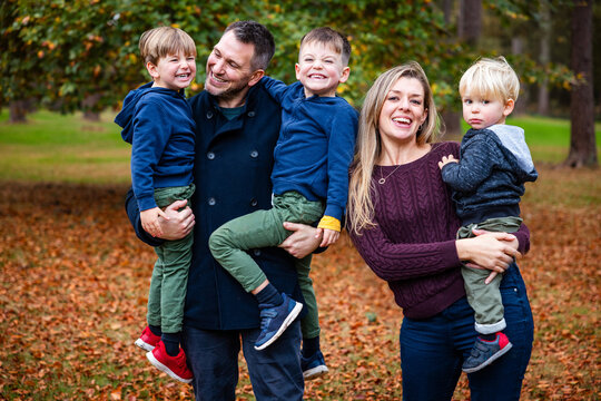 Happy family with three children enjoying autumn park