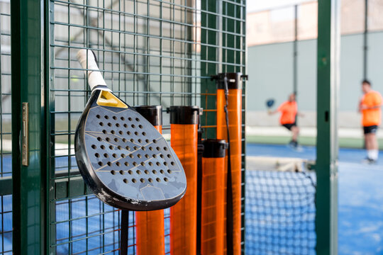 Padel racket beside court during doubles match