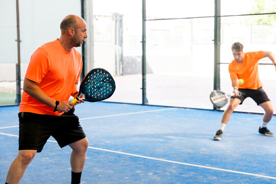 Padel doubles match with two players on indoor court