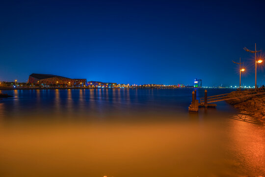 Kuwait City Skyline at Blue Hour Reflected in the Arabian Gulf Waters at Dusk. Kuwait City skyline view.