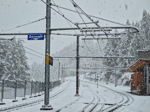 Snow-covered railway track at Zermatt station in winter