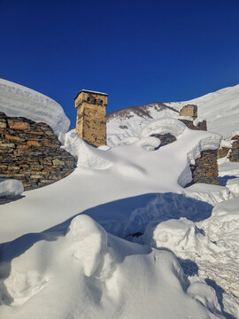 Snow-covered stone ruins in winter mountain landscape