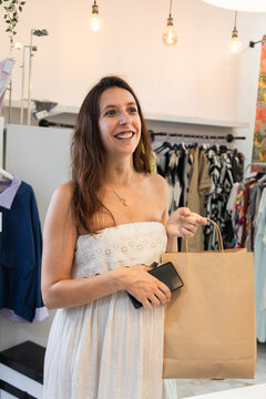 Pregnant woman shop for fashion apparel in boutique