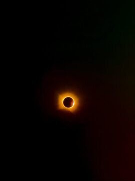 Solar eclipse with glowing corona in dark space