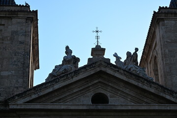 Naklejka premium Church Facade with Statues of Saints and a Cross