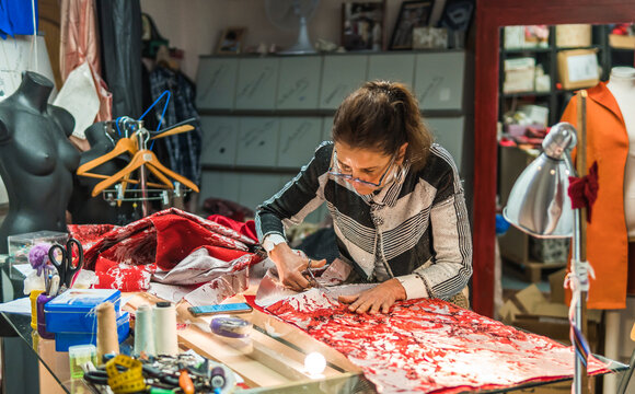 Fashion designer creating handmade dress in atelier workshop