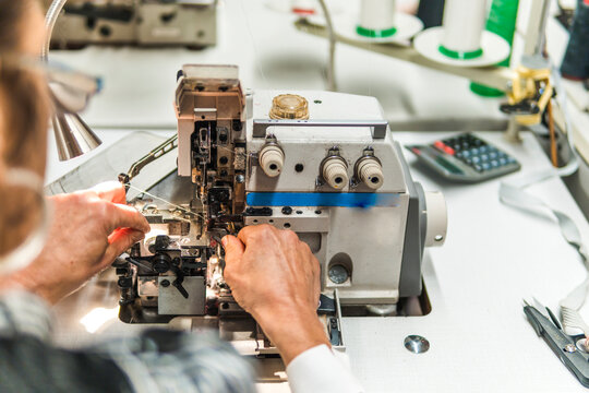 Modiste prepare overlock sewing machine for garment production