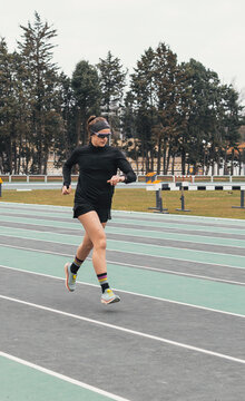 Female athlete run on outdoor track during training
