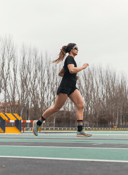 Female athlete run on track during outdoor training