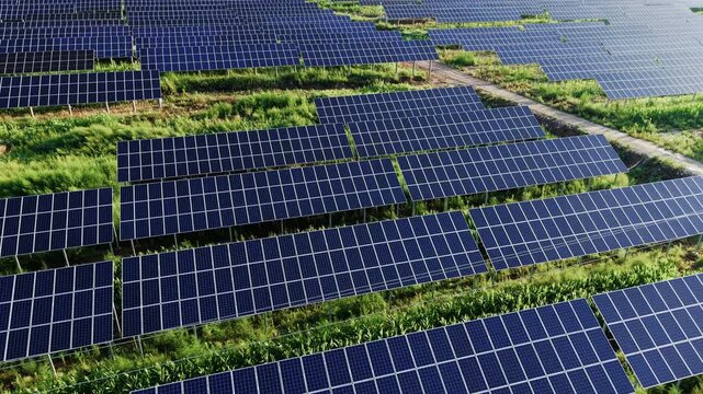 Aerial drone shot gliding forward right over rows of blue solar panels on a water surface. Clean renewable energy, sustainable photovoltaic power, and ecological ESG technology.