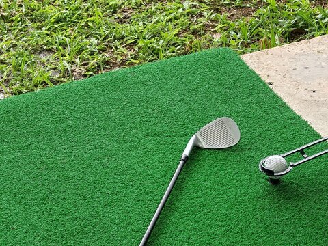 Golf Club and Ball on Turf Mat with Grass Border