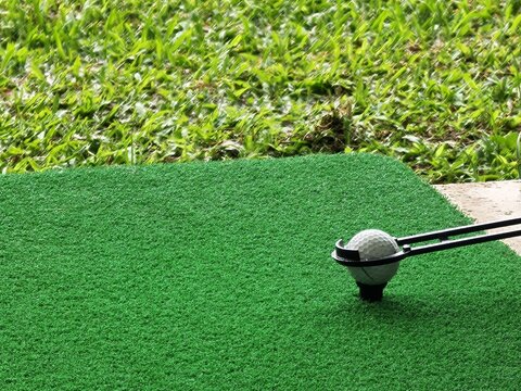 Golf Ball on Tee with Copy Space on Driving Range