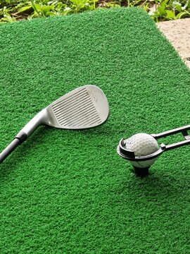 Vertical Golf Wedge and Teed Ball on Artificial Turf