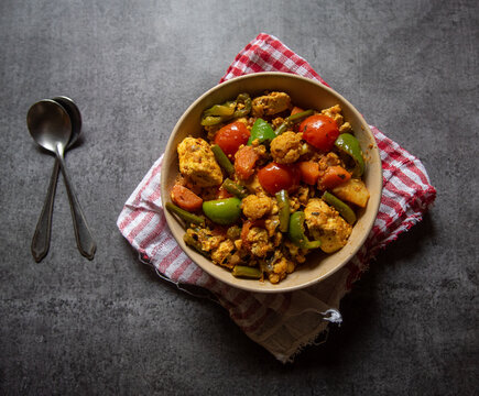 Kadai paneer, a popular north Indian semi dry dish made by cooking paneer or cottage cheese tomatoes and bell peppers with fresh ground spices. Top view.