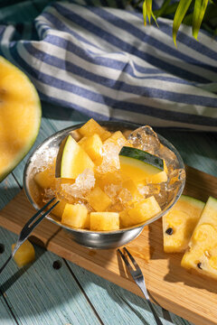 Yellow watermelon dessert with crushed ice and mint