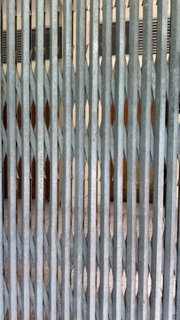 An old metal accordion gate provides security for an entrance