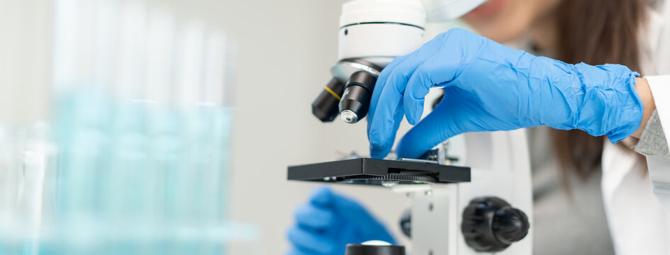 researcher using microscope analyse cell in medical lab.