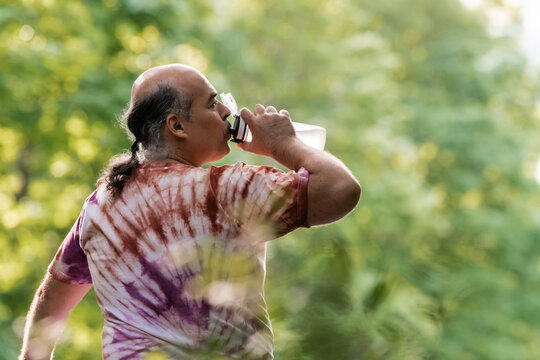 Mature man hydrate during outdoor wellness walk