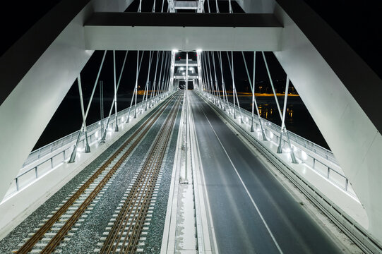 Aerial night view of illuminated bridges over a river.
