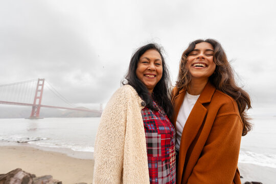 joyful mom and adult daughter together portrait golden gate bridge SF
