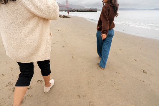 casual friends walking on beach together beach cloudy day