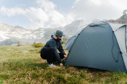 Pitching Tent In The Mountains