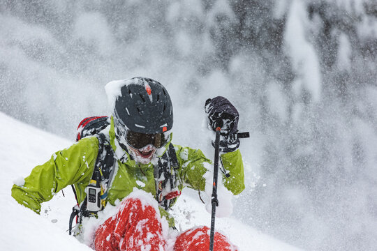 Freeride skier getting up after falling in deep powder snow
