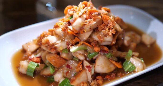Close up of spicy Thai santol fruit salad topped with dried shrimp